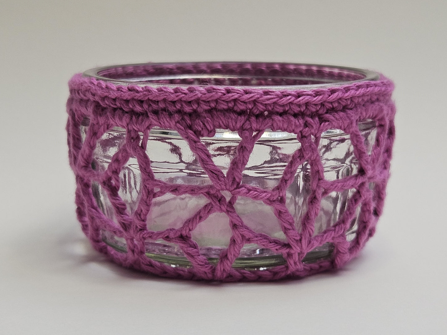Crocheted cover on a glass ramekin.